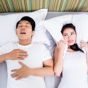 Chinese man snoring keeping his unhappy wife awake
