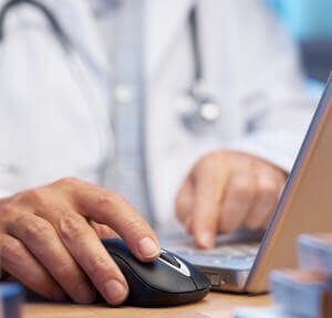 Doctor preparing online internet prescription selective focus electronic medical record EMR physician computer
