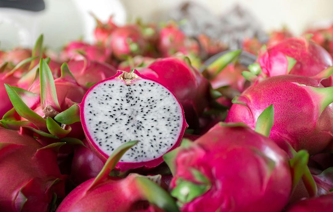 Dragon fruit that has been cut in half for product display. dragon fruit which are beautifully arranged in baskets to prepare for export sale. Dragon fruit of agriculture product on natural background
