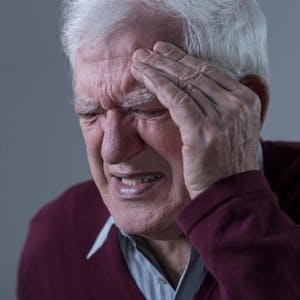 Elderly upset man with terrible headache, horizontal

