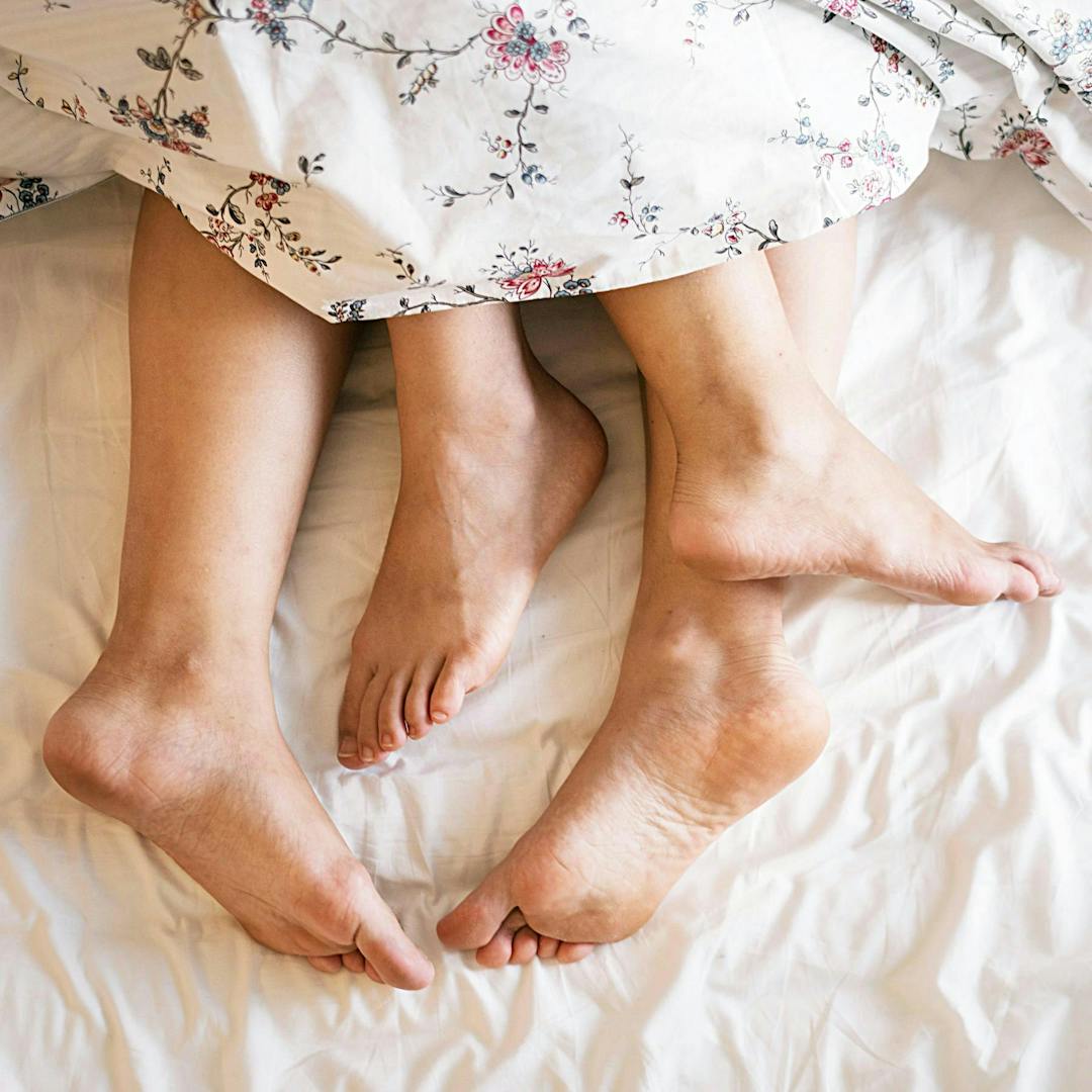 Cc0 from https://www.pexels.com/photo/two-people-laying-on-a-bed-covered-with-a-floral-comforter-1246960/
