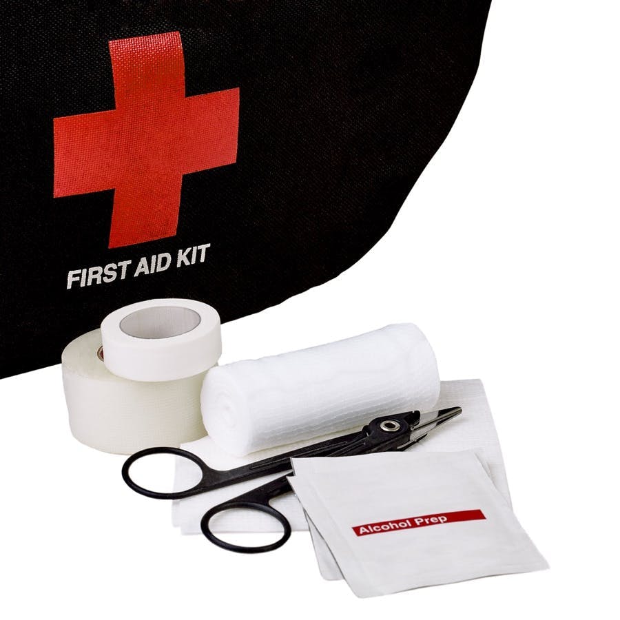 First Aid Kit bag with White gauze bandage roll and pad with alcohol prep wipe medical scissors and medical tape isolated on white
