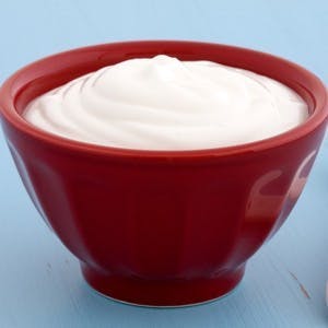 Delicious nutritious and healthy fresh plain greek yogurt on antique wood table
