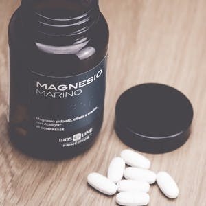Inverigo Italy &#8211; September 9 2016: marine magnesium citrate tablets Bios Line nutritional supplement in a glass bottle
