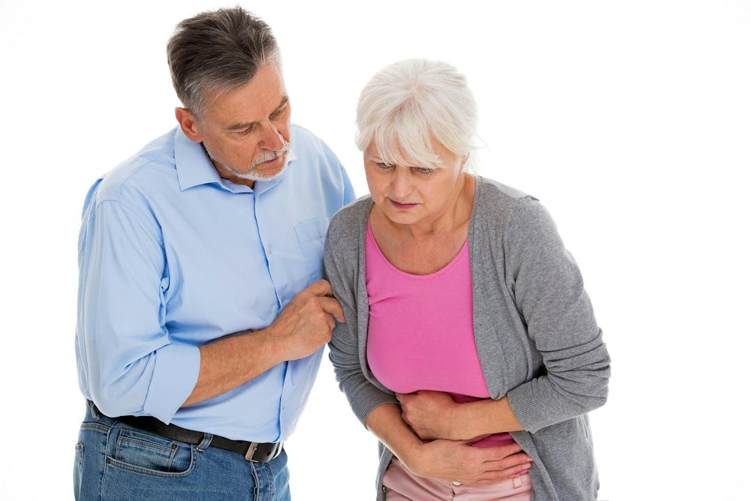 Man helping woman with a stomach pain
