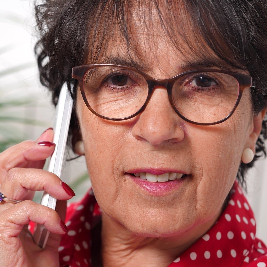 A portrait of mature brunette woman talking on phone
