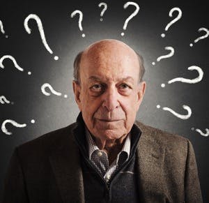 Old man confused with many question marks
