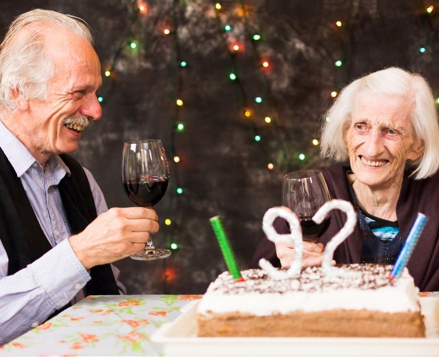 Grandma celebrating birthday with her elderly son
