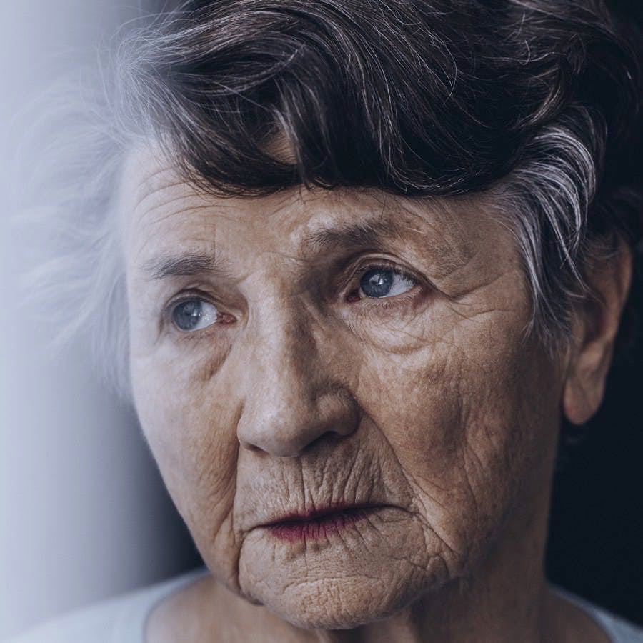 Close-up of worried lonely old woman&#8217;s face with wrinkles
