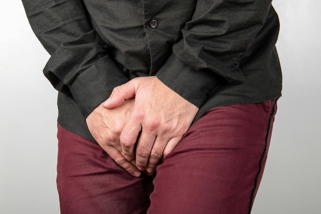 Urinary and prostate problems in men. Male holding intimate parts
