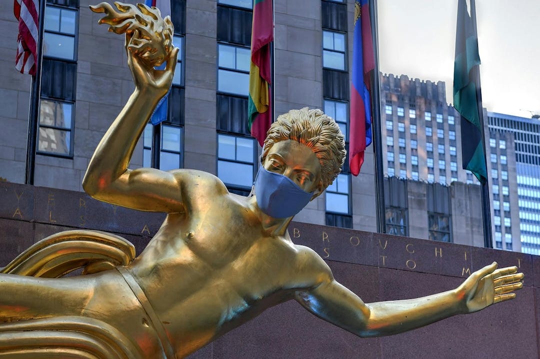 New York, NY / USA &#8211; Jul 2, 2020: Real estate firm Tishman Speyer fitted masks on Prometheus and other classic statues in Rockefeller Center to remind New Yorkers to wear COVID-19 face coverings.
