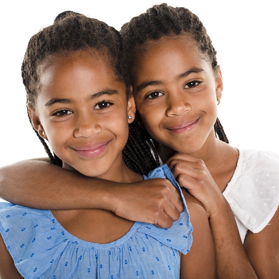 Adorable african twin girl on studio white background
