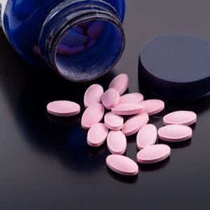 Vitamin B-12 Dietary Supplement Pills Spilt From Container

