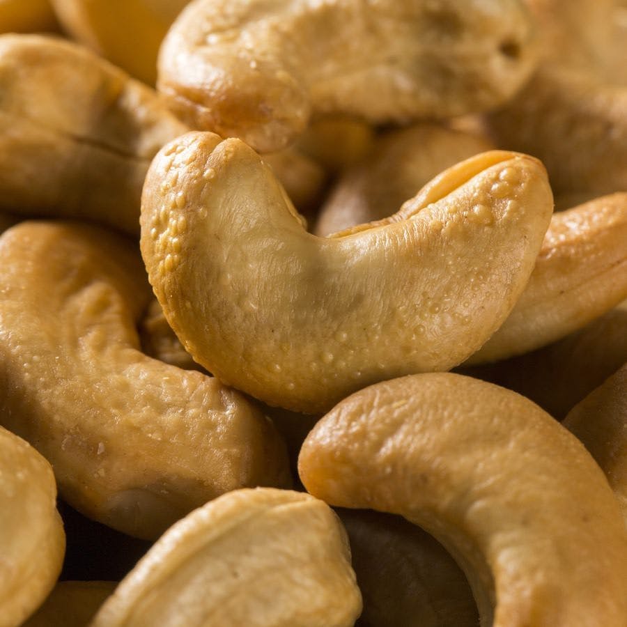 Cashew nuts close up on wood background
