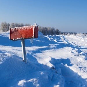 Photo of a winter frozen mail box under snow
