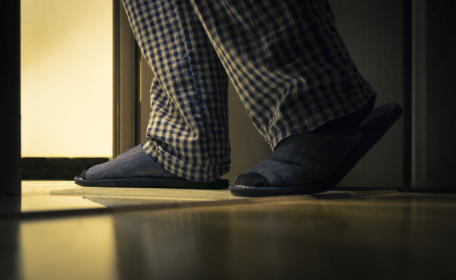 Adult man in pijamas walks to a bathroom at the night. Men&#8217;s healths concept
