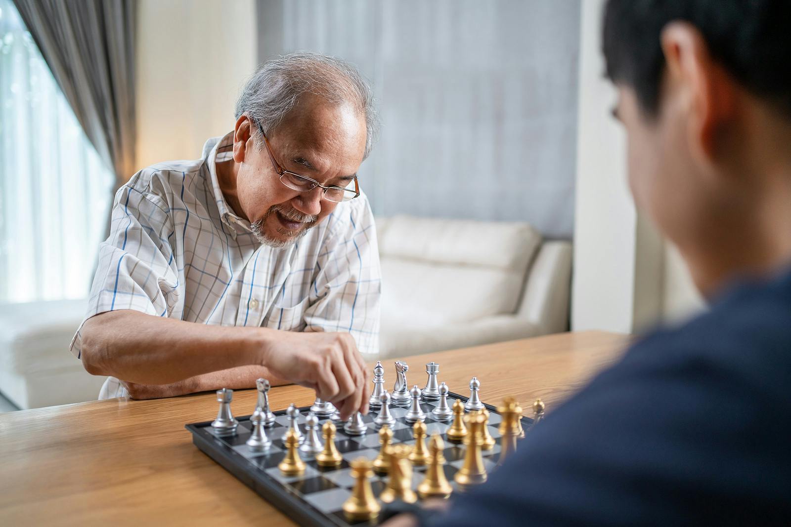 Older man playing chess. Mental activity can help keep your brain healthy so you stay sharp